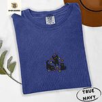 True Navy Comfort Colors T-shirt embroidered with three black cats pouncing, leaping and sitting among falling red, orange and yellow autumn leaves