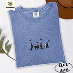 Blue Jean Comfort Colors T-shirt embroidered with four black cat silhouettes in Santa hats reaching for holly across the chest