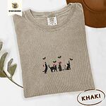 Khaki Comfort Colors T-shirt embroidered with four black cat silhouettes in Santa hats reaching for holly across the chest