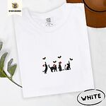 White Comfort Colors T-shirt embroidered with four black cat silhouettes in Santa hats reaching for holly across the chest