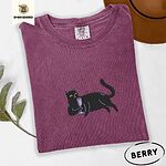 Berry Comfort Colors T-shirt embroidered with a black cat lounging on its side holding a stemmed glass of pink wine