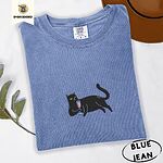 Blue Jean Comfort Colors T-shirt embroidered with a black cat lounging on its side holding a stemmed glass of pink wine
