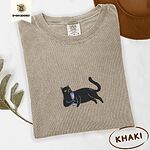 Khaki Comfort Colors T-shirt embroidered with a black cat lounging on its side holding a stemmed glass of pink wine
