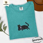 Seafoam Comfort Colors T-shirt embroidered with a black cat lounging on its side holding a stemmed glass of pink wine