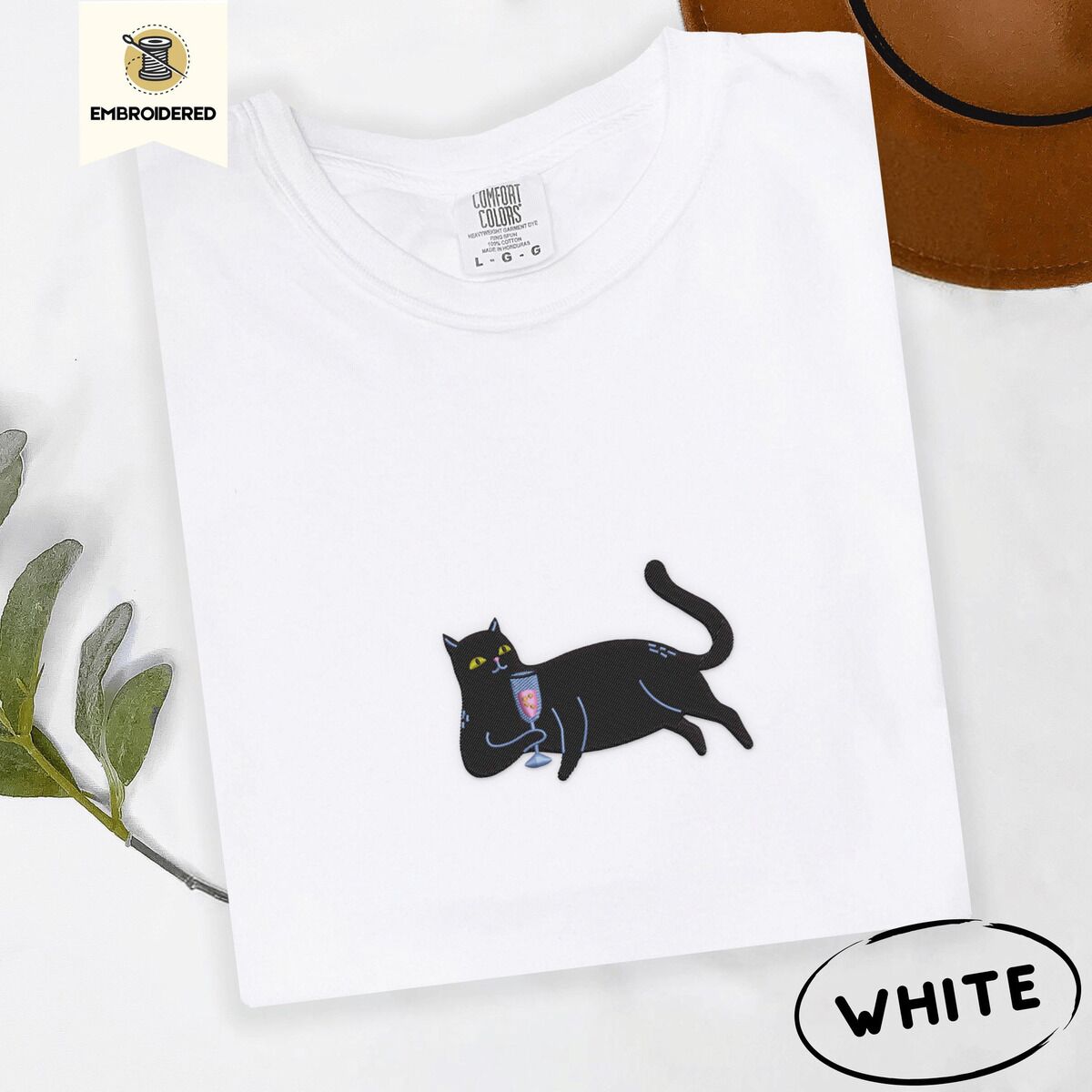 Black Cat Wine Shirt – White White Comfort Colors T-shirt embroidered with a black cat lounging on its side holding a stemmed glass of pink wine