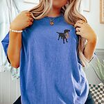 Woman in a Flo Blue T-shirt with a black Labrador and a little flag on the left chest