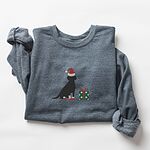 Dark Heather crewneck sweatshirt laid flat with rolled sleeves, embroidered with a sitting black Labrador in a Santa hat and red booties beside a green gift box