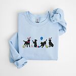 Light Blue crewneck sweatshirt laid flat, embroidered with four black lab silhouettes in bunny ears with a little bunny, Easter eggs, daffodils and a blue balloon