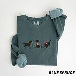 Blue Spruce crewneck sweatshirt laid flat with rolled cuffs, embroidered with three black Labradors, one in an elf hat carrying Christmas lights, one in a candy-cane scarf and one in a Santa hat pawing a gift