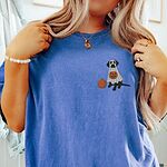 Woman in a Flo Blue T-shirt embroidered with a small black Labrador in a ghost costume holding a jack-o'-lantern bucket
