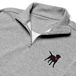 Close-up of the embroidered black lab on the chest of a grey quarter zip: a standing black Labrador with its tail up, head turned back and a hot pink collar and tag