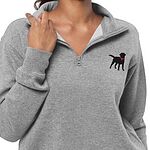 Woman wearing a grey black lab quarter zip, holding the collar, with the black Labrador and pink collar embroidered on the left chest