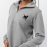 Woman in a grey quarter zip pullover turned to the side, showing the embroidered black lab with a pink collar on the left chest