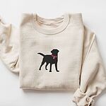 Sand crewneck sweatshirt with a larger black Labrador silhouette in a hot pink collar and tag centered on the chest