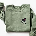 Military Green crewneck sweatshirt laid flat on white, embroidered with a small black Labrador silhouette in a hot pink collar and tag on the left chest