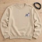Pit bull embroidery stitched in blue-gray thread to match a blue pitbull, on a sand crewneck sweatshirt