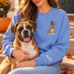 Boxer mom wearing the Heather Deep Royal Halloween sweatshirt with her Boxer on a fall porch