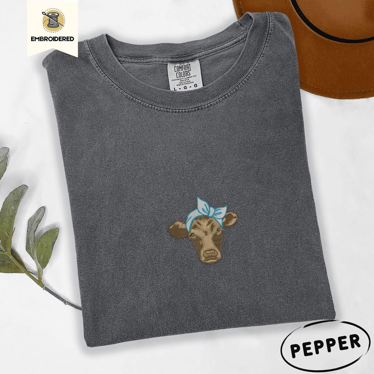 Brown Cow Shirt – Pepper Pepper Comfort Colors T-shirt embroidered with a brown calf head wearing a light blue bandana tied in a bow