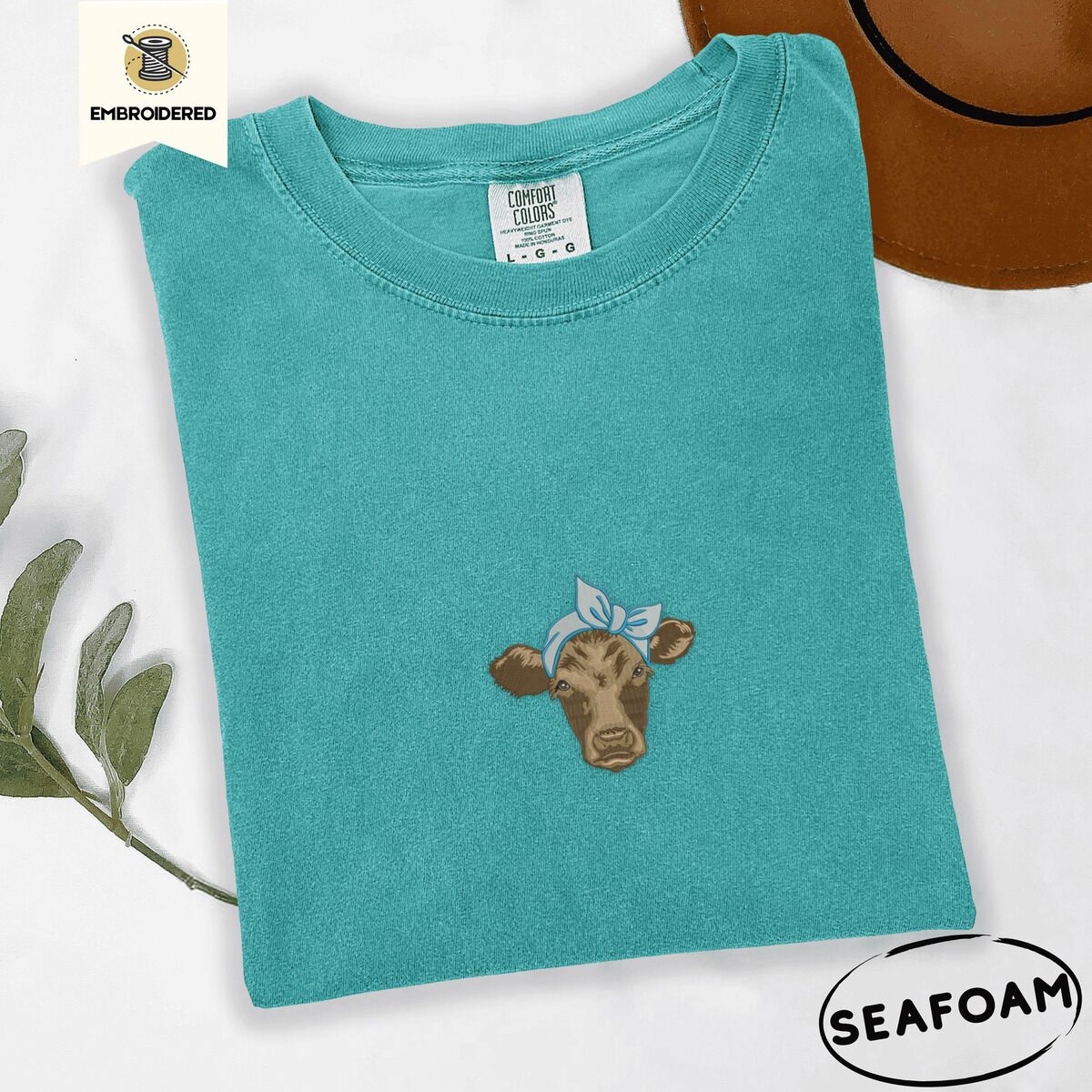 Brown Cow Shirt – Seafoam Seafoam Comfort Colors T-shirt embroidered with a brown calf head wearing a light blue bandana tied in a bow
