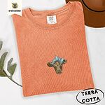 Terracotta Comfort Colors T-shirt embroidered with a brown calf head wearing a light blue bandana tied in a bow