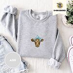 Ash crewneck sweatshirt folded with denim shorts, white sneakers and a potted plant, embroidered with a brown calf head wearing a light blue bandana tied in a bow