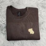 Capybara crewneck in Dark Chocolate with the embroidered capybara on the left chest