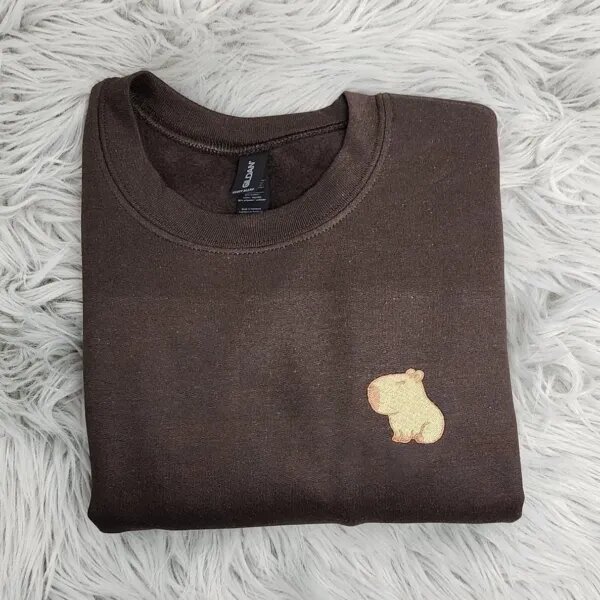 Capybara crewneck in Dark Chocolate with the embroidered capybara on the left chest