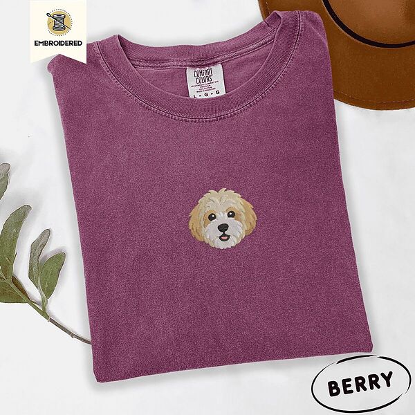 Berry Comfort Colors T-shirt embroidered with a mini Cavachon face in cream and apricot with a white muzzle