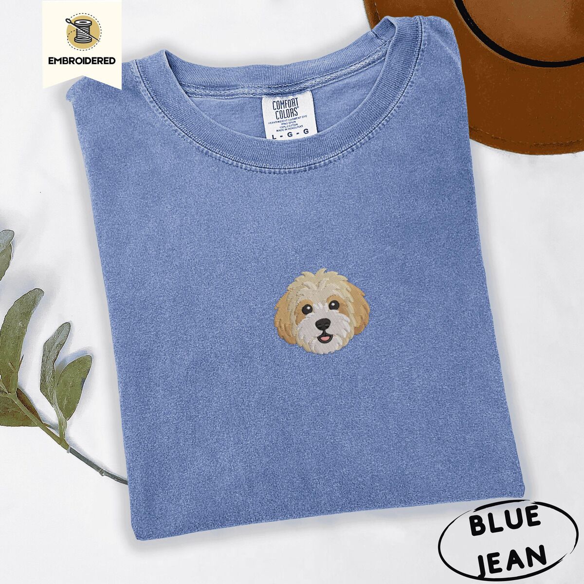 Cavachon Shirt – Blue Jean Blue Jean Comfort Colors T-shirt embroidered with a mini Cavachon face in cream and apricot with a white muzzle