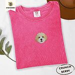 Crunchberry Comfort Colors T-shirt embroidered with a mini Cavachon face in cream and apricot with a white muzzle