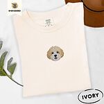 Ivory Comfort Colors T-shirt embroidered with a mini Cavachon face in cream and apricot with a white muzzle