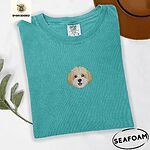 Seafoam Comfort Colors T-shirt embroidered with a mini Cavachon face in cream and apricot with a white muzzle