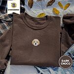 Dark Chocolate crewneck sweatshirt on a plaid flannel shirt with yellow autumn leaves and denim shorts, embroidered with a mini Cavachon face in cream and apricot with a white muzzle