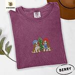 Berry Comfort Colors T-shirt embroidered with two Blenheim Cavalier King Charles Spaniels in knit beanies beside a little lit Christmas tree