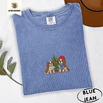 Blue Jean Comfort Colors T-shirt embroidered with two Blenheim Cavalier King Charles Spaniels in knit beanies beside a little lit Christmas tree