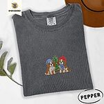 Pepper Comfort Colors T-shirt embroidered with two Blenheim Cavalier King Charles Spaniels in knit beanies beside a little lit Christmas tree