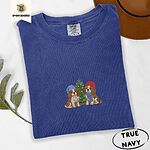 True Navy Comfort Colors T-shirt embroidered with two Blenheim Cavalier King Charles Spaniels in knit beanies beside a little lit Christmas tree