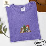 Violet Comfort Colors T-shirt embroidered with two Blenheim Cavalier King Charles Spaniels in knit beanies beside a little lit Christmas tree