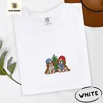 White Comfort Colors T-shirt embroidered with two Blenheim Cavalier King Charles Spaniels in knit beanies beside a little lit Christmas tree