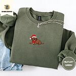 Military Green crewneck sweatshirt folded with light jeans and a silver chain necklace, embroidered with a chocolate lab puppy in a Santa hat and red scarf in the center of the chest