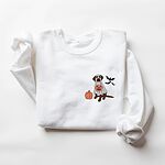 White crewneck sweatshirt laid flat on a white background, embroidered with a chocolate lab in a ghost costume beside a pumpkin and three bats