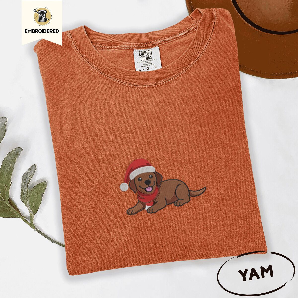 Chocolate Lab Santa Hat Shirt – Yam Yam Comfort Colors T-shirt embroidered with a chocolate Labrador puppy lying down in a red Santa hat and a red knit scarf