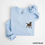 Light Blue crewneck sweatshirt laid flat on white, embroidered with a small chocolate brown Labrador silhouette in a blue collar and gold bone tag on the left chest
