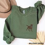 Military Green crewneck sweatshirt laid flat with a hat and a necklace, embroidered with a small chocolate brown Labrador silhouette in a blue collar and gold bone tag on the left chest