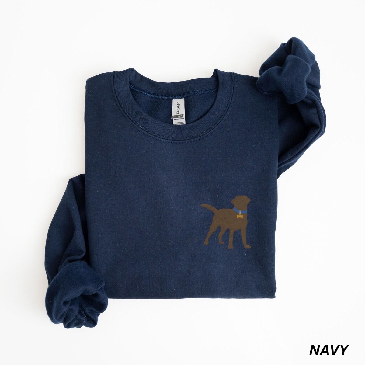 Chocolate Lab Silhouette Sweatshirt – Navy Navy crewneck sweatshirt laid flat on white, embroidered with a small chocolate brown Labrador silhouette in a blue collar and gold bone tag on the left chest
