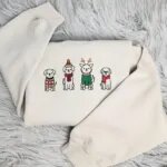 Christmas dog crewneck in Sand with four embroidered dogs in a holiday sweater, a pom-pom hat, reindeer antlers and a red scarf