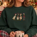 Woman wearing the Forest Green Christmas duck sweatshirt next to a Christmas tree