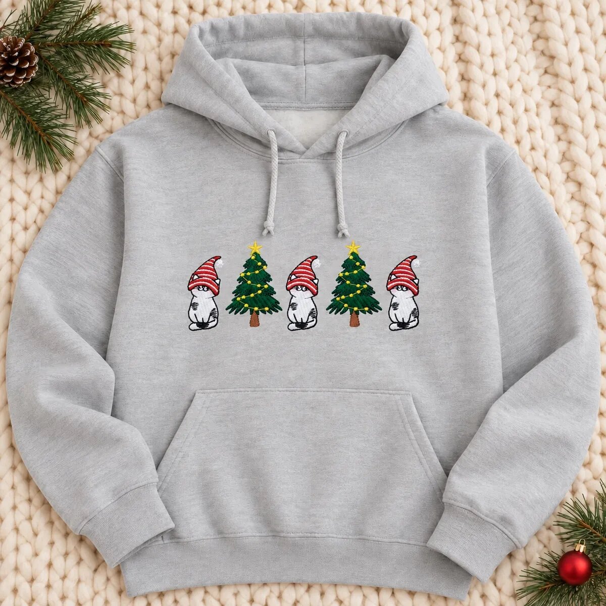 Christmas Gnome Cat Hoodie – Ash Christmas gnome cat hoodie in Ash with the embroidered cats and trees below the drawstrings