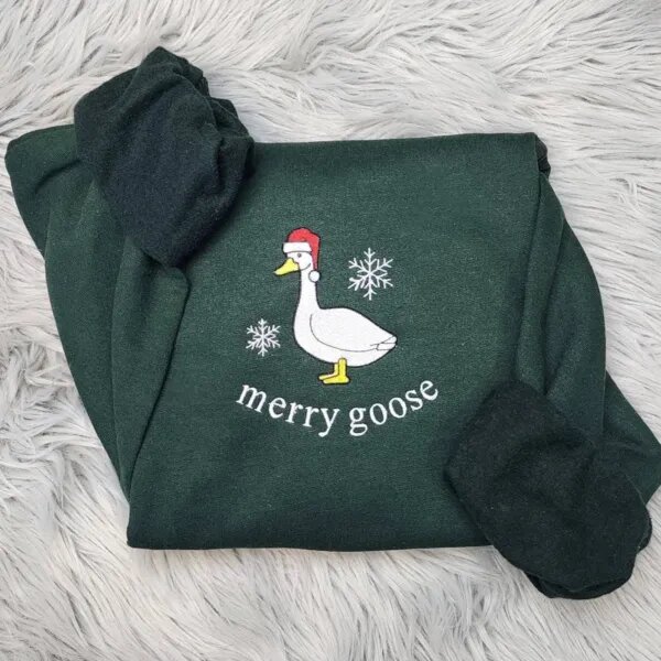 Christmas goose sweatshirt in Forest Green with a white goose in a Santa hat, snowflakes and the words merry goose