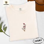 Ivory Comfort Colors T-shirt embroidered with a cream goose in a Santa hat with a red ribbon bow at its neck